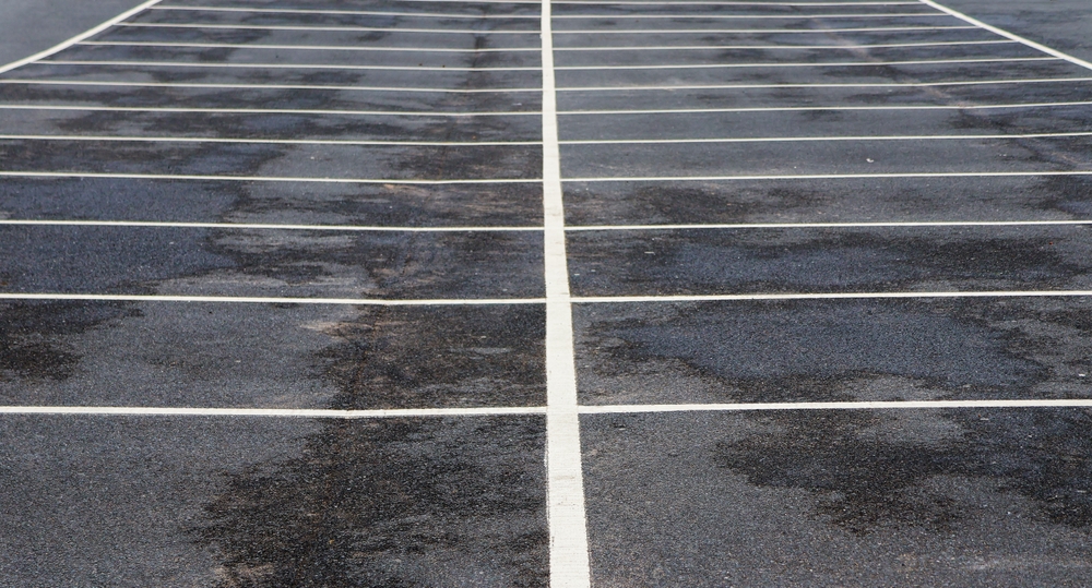 Empty,Parking,Lot,With,Clean,White,Lines,On,Wet,Asphalt,